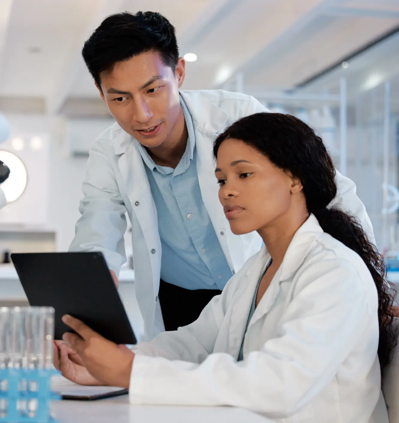 Two medical device experts looking at a tablet screen.