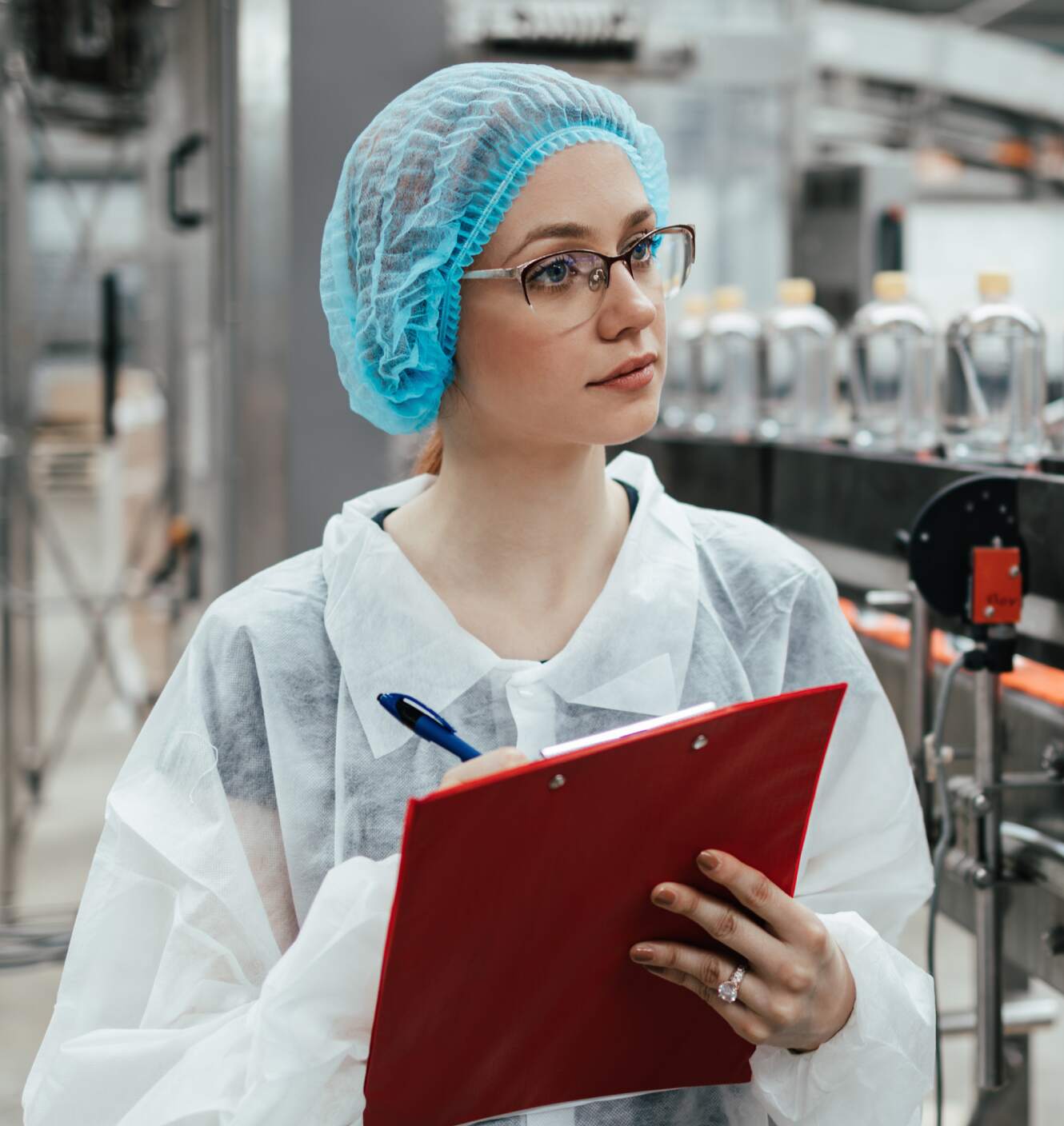 A medical manufacturing specialist writing on clipboard.